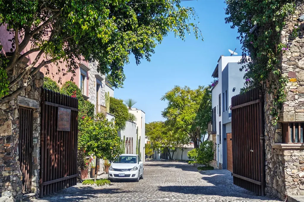 Tree-lined cobblestone street in Obraje San Miguel de Allende