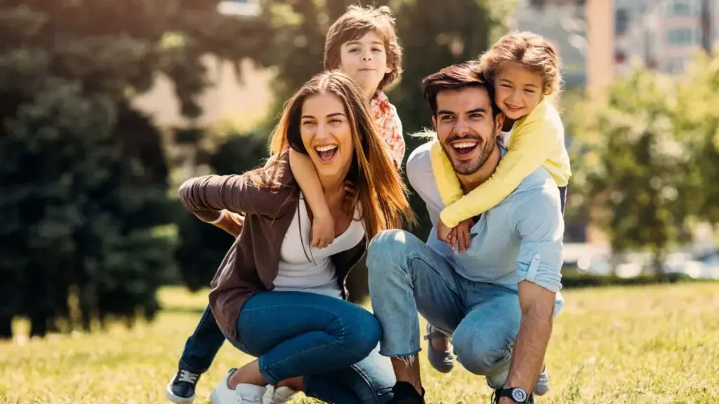 Happy family with two young children playing outdoors in San Miguel de Allende, enjoying the city's parks and family-friendly lifestyle.
